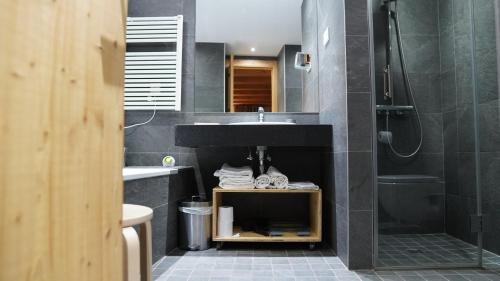 a bathroom with a sink and a shower at Cal Batlle Casa Rural in La Cortinada