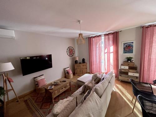 a living room with a couch and a table at «La Calade » Villa les Glycines in Collioure