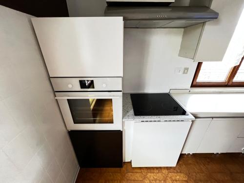 a kitchen with white cabinets and an oven at Villa Gianfranca - sentiti come a casa in Corno di Rosazzo
