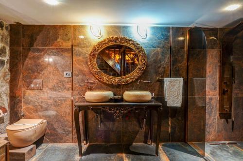 a bathroom with a toilet and a mirror at Kerem ile Aslı Butik Hotel in Melikgazi