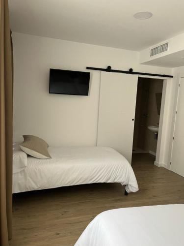 Ένα ή περισσότερα κρεβάτια σε δωμάτιο στο Hostal Márquez