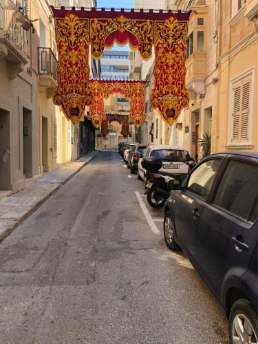 a street with cars parked on the side of a building at Lee House in Sliema