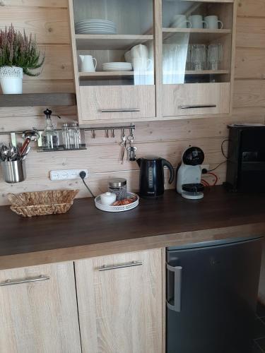 a kitchen with wooden cabinets and a counter top at Purvēveri in Tukums