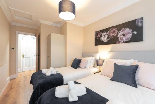 a bedroom with two beds and a large window at Central 1BED APT RELIABLE FAST WIFI & TV in Dublin