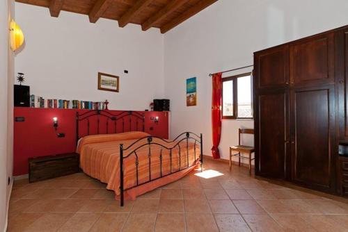 a bedroom with a bed with a red head board at Terrazza delle mura in Cefalù