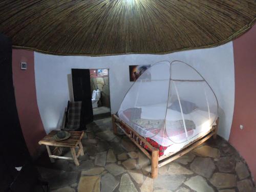 an aerial view of a room with a bed in a house at Red Rocks Rwanda - Campsite Guesthouse in Nyakinama