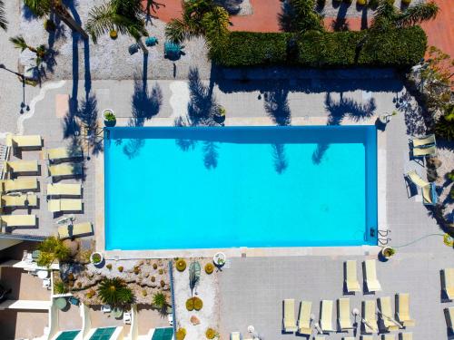 an overhead view of a large swimming pool with chairs at Casthotels Punta del Sole Terme in Ischia
