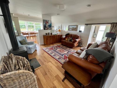 a living room with a couch and a chair at Teal Cottage, Killlyleagh in Killyleagh