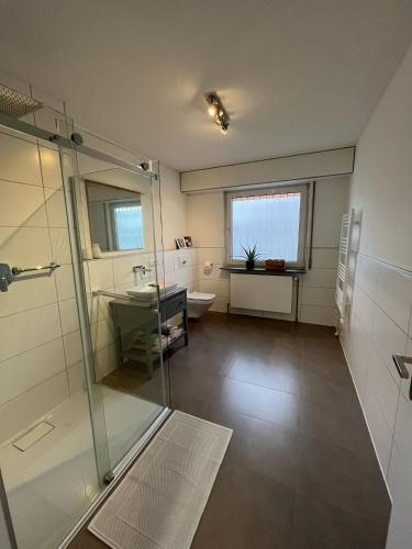 a bathroom with a shower and a sink and a toilet at Ferienwohnung Wendel in Sankt Wendel
