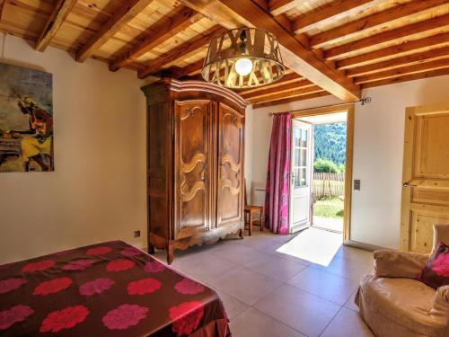 a living room with a large wooden cabinet and a couch at Gîte La Valla-sur-Rochefort, 5 pièces, 10 personnes - FR-1-496-44 in La Valla