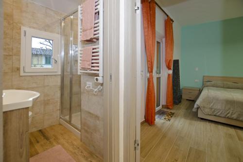 a bathroom with a shower and a sink and a bed at Casina Valentina - Happy Rentals in Florence