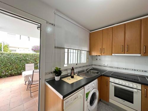 a kitchen with a sink and a dishwasher at Novo Sancti Petri Atardecer Planta baja in Chiclana de la Frontera