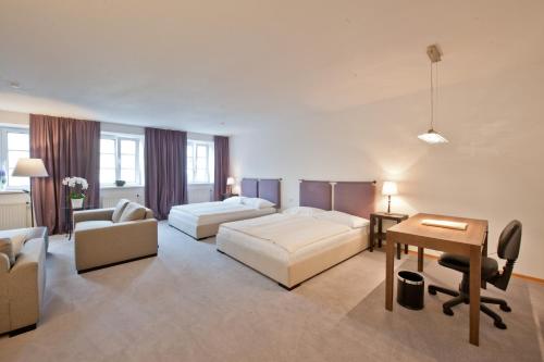 a large living room with a bed and a desk at Hotel Forstinger - Boutique Hotel Schärding in Schärding