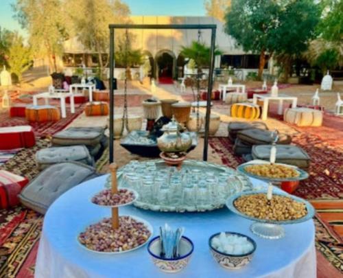 a table with bowls of food on top at Galaxy stars camp in Hassilabied