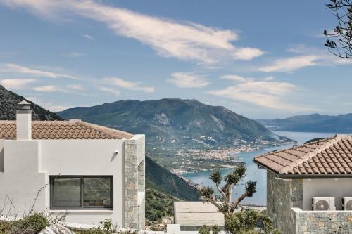 a house with a view of the ocean and mountains at Escape View Villa Lefkada in Fternón