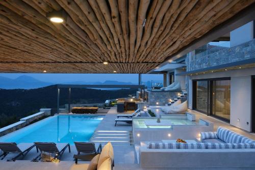 an outdoor patio with a swimming pool and a house at Escape View Villa Lefkada in Fternón