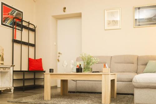 a living room with a couch and a table at Kamena kuća in Požega