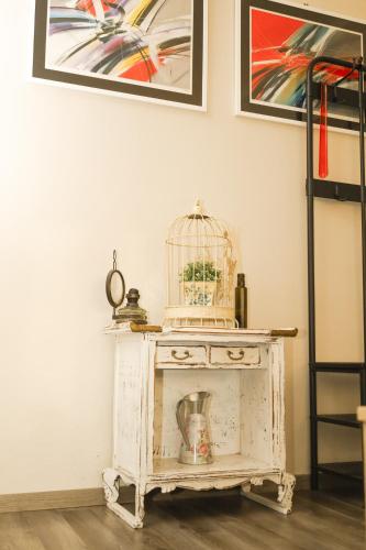 a bird cage sitting on a table in a room at Kamena kuća in Požega
