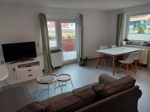 a living room with a couch and a table at Haus Sandkorn in Baltrum
