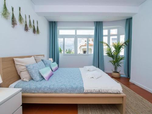 a bedroom with a large bed with a window at Villa Double Joy - Privacy & Privat Pool & Garden & Top Location & Albufeira in Albufeira