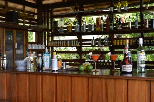 a bar with bottles of alcohol and glasses on it at The Amazing Villa in Anepahan