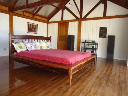 a bedroom with a large wooden bed in a room at The Amazing Villa in Anepahan