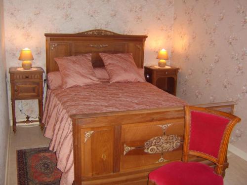 a bedroom with a wooden bed with two night stands at Gîte Saint-Héand, 2 pièces, 2 personnes - FR-1-496-144 in Saint-Héand