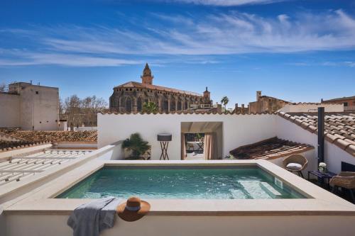 a swimming pool on the roof of a house at Boutique Hotel Posada Terra Santa in Palma de Mallorca