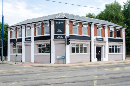 a building on the corner of a street at Trivelles Eccles in Manchester