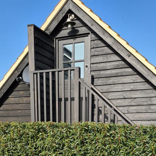 a window on the side of a wooden house at The Cartshed, Coltishall, Norfolk in Norwich