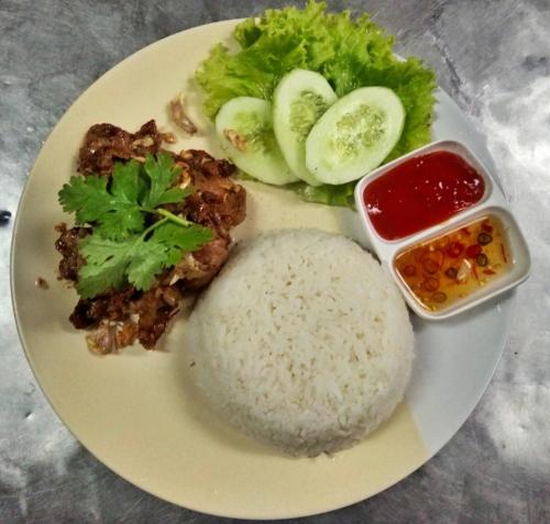 a white plate of food with rice and vegetables at the L Hua Hin in Hua Hin
