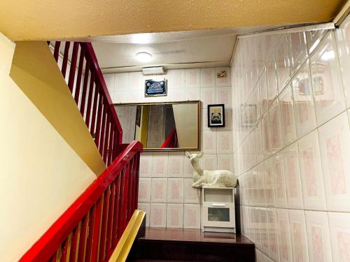 a room with a red staircase with a fake animal on the wall at Al Wehda Hotel in Dubai