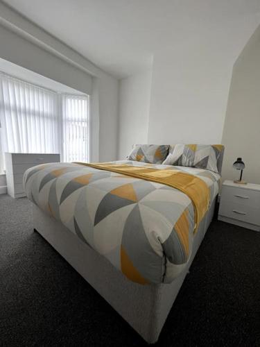 a bedroom with a large bed in a white room at No. 10 - Home away from Home in Litherland