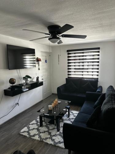 a living room with a couch and a ceiling fan at Departamento en Torres Reyes ll in Tijuana