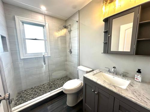 a bathroom with a shower and a toilet and a sink at Belmar NJ 5 Min Walk to Beach, Sleeps 16+ in Belmar
