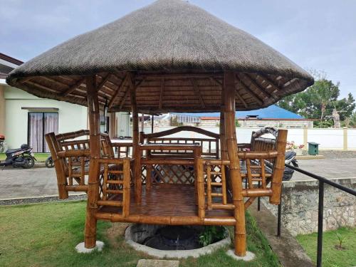 a large umbrella sitting on top of a yard at Mango Prima in Moalboal