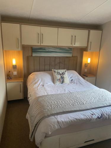 a bedroom with a large bed with a pillow on it at Otters Rural Retreat - Private Hot-Tub & Free Golf for guests included in Swarland