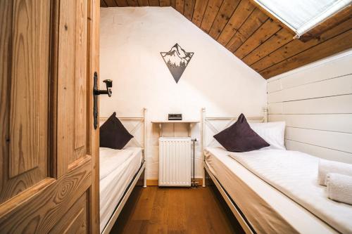 two beds in a small room with a window at MountainView Lodge - Am Fuße der Gondel und Skipiste in Sankt Oswald