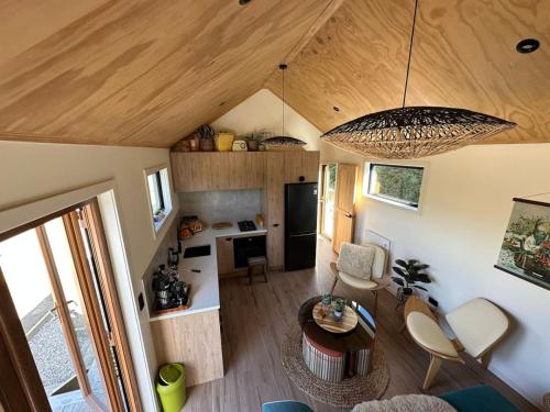 an open living room with a kitchen and a dining room at Petite Perfection tiny house at Lake Hawea in Lake Hawea