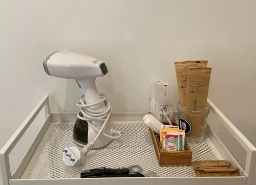 a bathroom with a blow dryer in the corner of a room at THE ROOM 115 in Rome