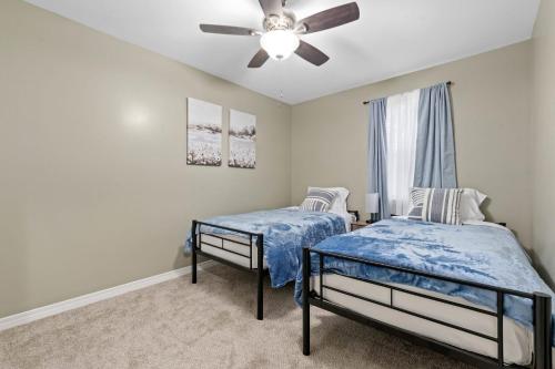 a bedroom with two beds and a ceiling fan at Renovated Home Perfect for Family in Mobile