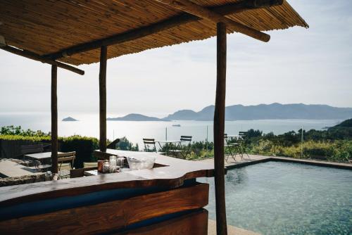 a swimming pool with a view of the water at Golfo dei Poeti Relais & Spa in Ameglia