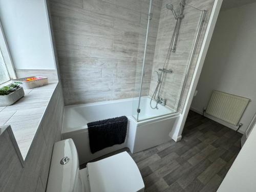 a bathroom with a shower and a white toilet at Scotch Terrace - 3 Bedrooms - Sleeps 6 in Whitehaven