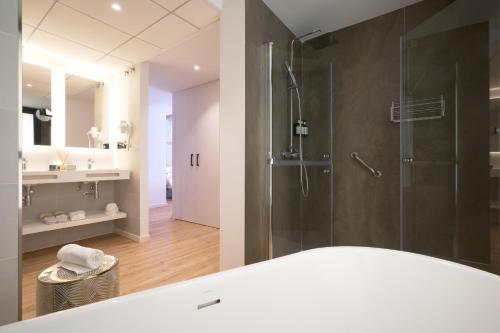 a bathroom with a shower and a sink at Óbal Hotel Marbella in Marbella