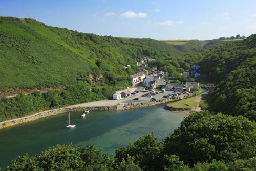 a river with boats in the middle of a town at Ty Gwennol St Davids in St. Davids