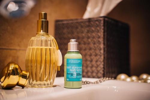 a bottle of soap sitting on a bathroom sink at BALTAZÁR Boutique Hotel in Budapest