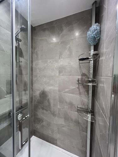 a bathroom with a shower with a glass door at Private ensuite room near London in Dagenham