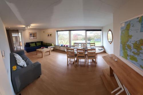 a living room with a table and a couch at Family Friendly Apt B, 900m to Lego House, parking, Legoland, Lalandia in Billund
