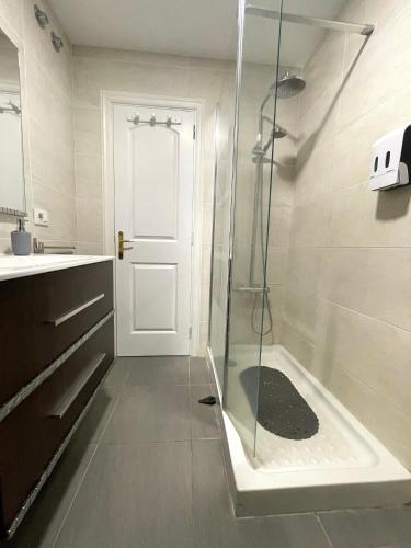 a bathroom with a shower with a glass door at Piera's Apartment in Chayofa