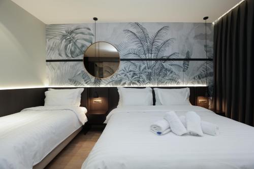 Postel nebo postele na pokoji v ubytování Gremmy Boutique Hotel